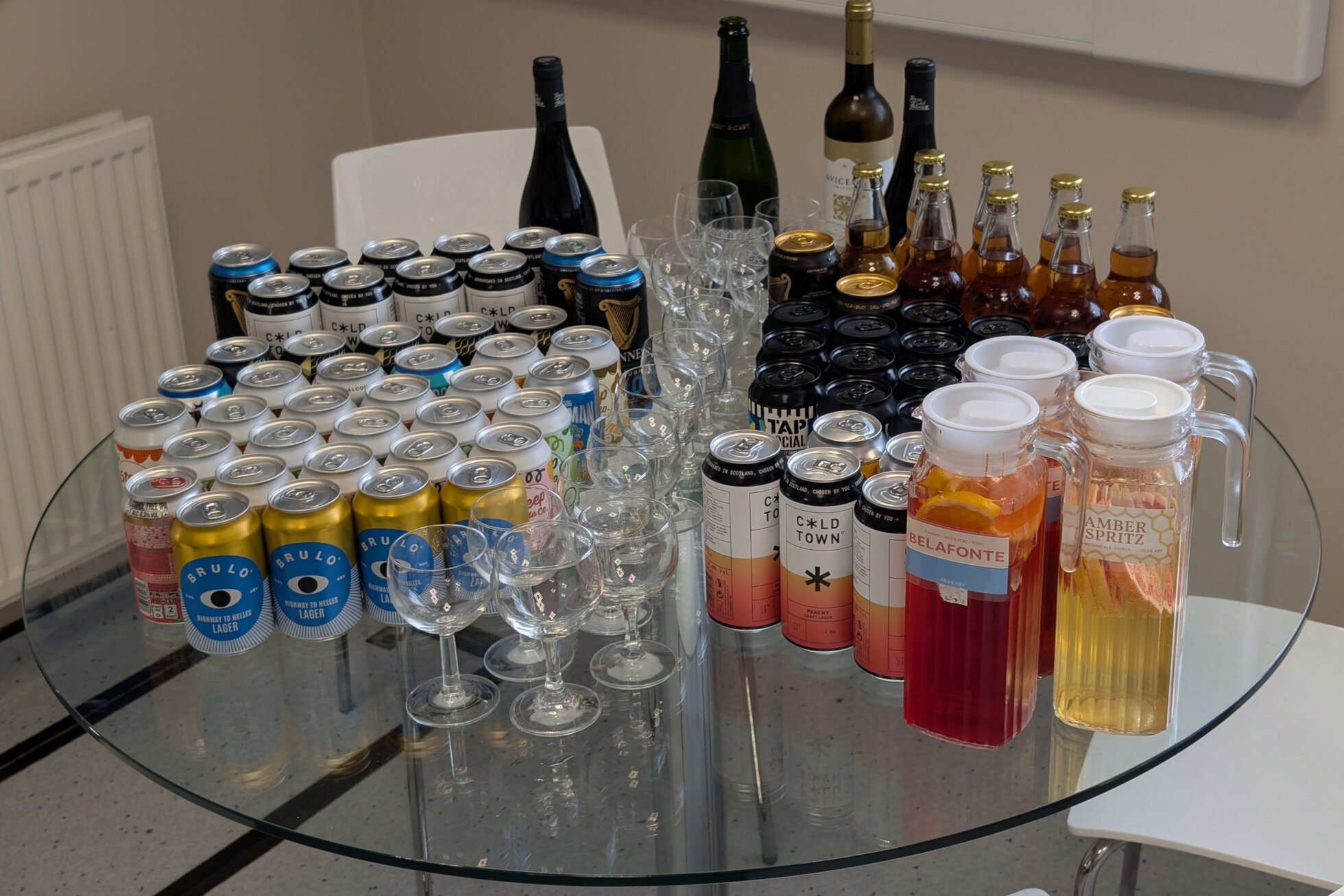A table with drinks on it, including an amber spritz.
